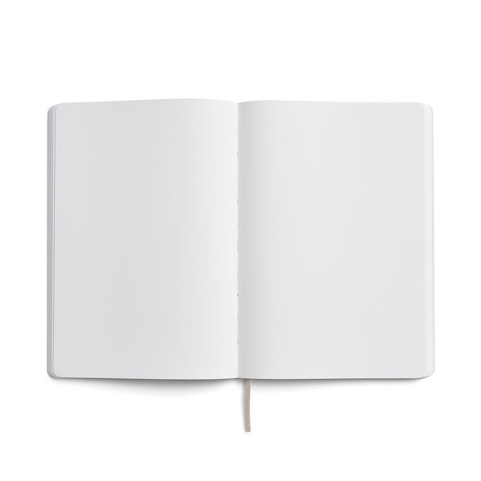 Karst A5 softcover stone paper notebook open to blank white pages with rounded corners and ribbon bookmark, displayed on a light gray background.