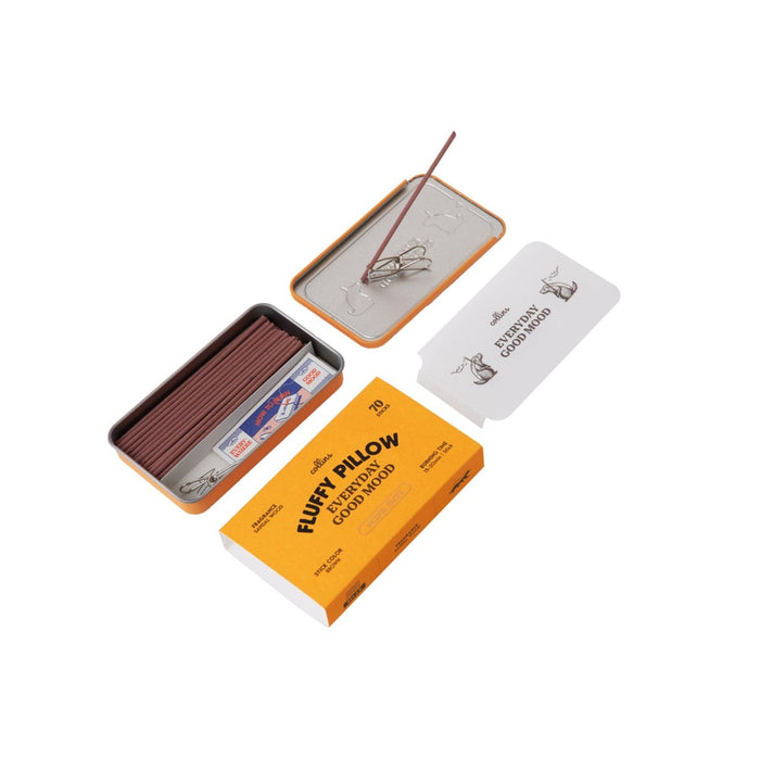 Collins Everyday Good Mood incense set labeled βFluffy Pillow,β shown open with brown incense sticks, metal clip holder, tray lid, and warm yellow packaging on a clean white background.