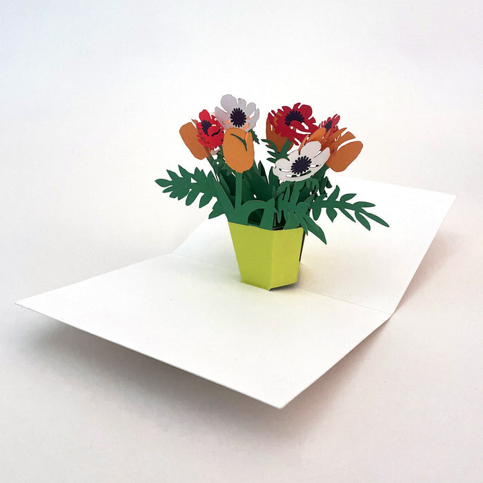 Open 3D pop-up greeting card featuring a vibrant bouquet of orange, red, and white paper flowers in a bright green vase, elegant floral paper art card for birthdays, thank you notes, and special occasions.