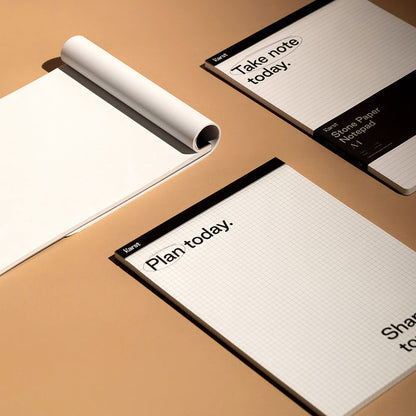 Karst A4 Stone Paper Notepad with grid and lined layouts on a desk, eco-friendly tear-off notepads for planning, note-taking, and productivity