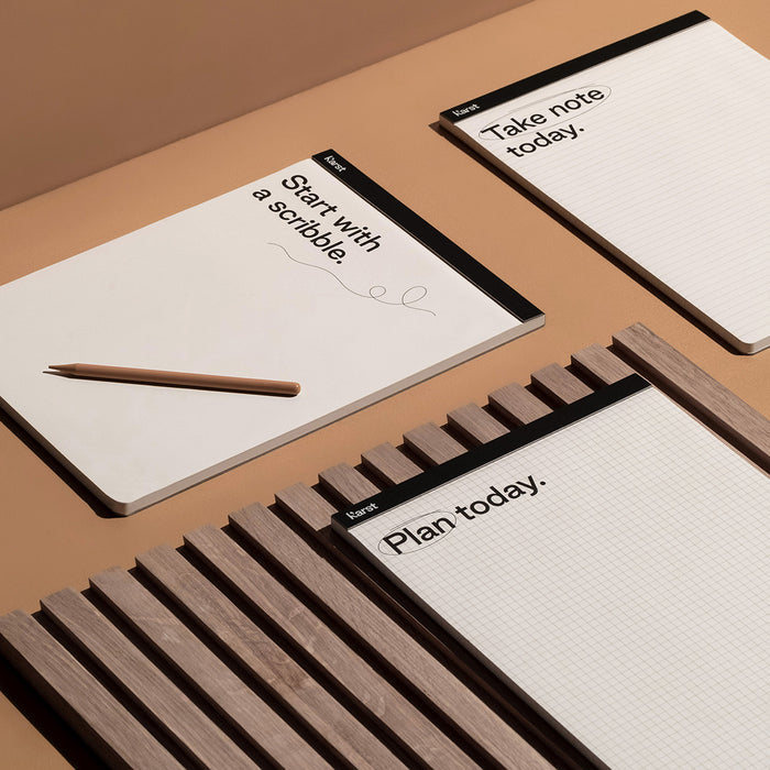 Karst A4 stone paper notepads with grid, lined, and blank pages arranged on a desk with pencil, eco-friendly tear-off pads for planning, notes, and sketching.