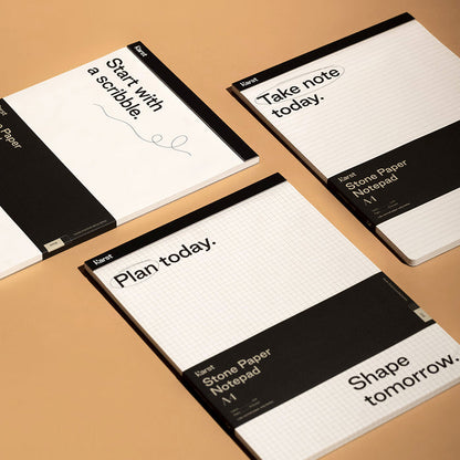 Karst A4 stone paper notepads with grid, lined, and blank layouts displayed on a desk, eco-friendly tear-off pads for planning, note-taking, and sketching.