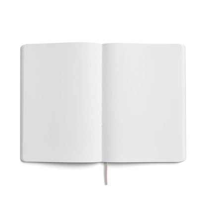 Karst A5 softcover stone paper notebook open to blank white pages with rounded corners and ribbon bookmark, displayed on a light gray background.