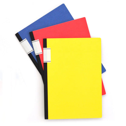 Set of 3 Ameico lined notebooks in yellow, red, and blue with black spines, featuring large minimalist journals arranged on a white background.