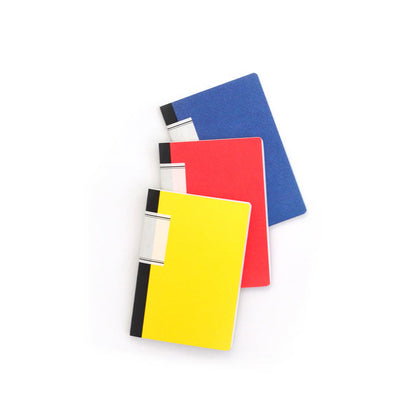 Set of 3 Ameico lined notebooks in yellow, red, and blue with black spines, featuring compact minimalist journals arranged on a white background.