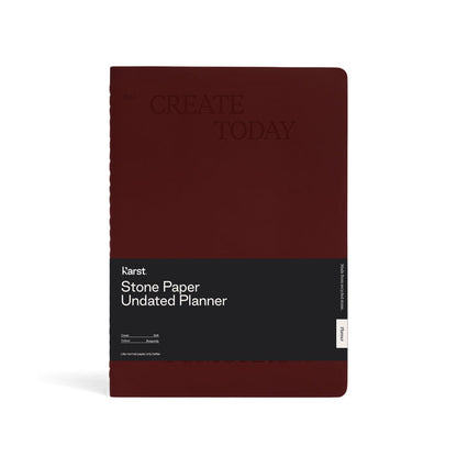 Front view of a burgundy Karst Stone Paper Undated Planner notebook with the phrase “Create Today” embossed on the cover and a black product band labeled “Stone Paper Undated Planner,” displayed against a white background.