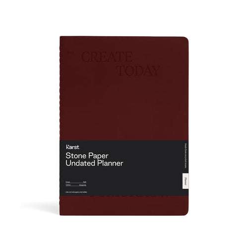 Front view of a burgundy Karst Stone Paper Undated Planner notebook with the phrase “Create Today” embossed on the cover and a black product band labeled “Stone Paper Undated Planner,” displayed against a white background.