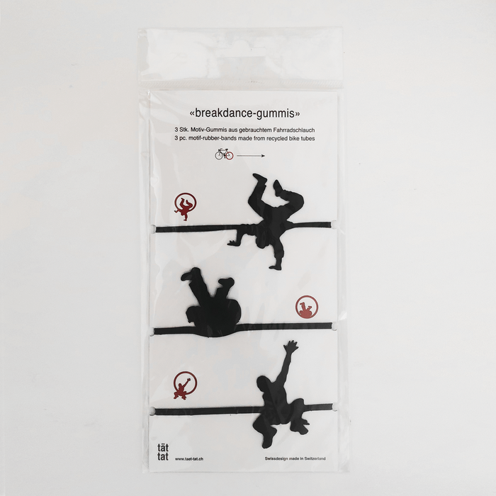 Pack of black breakdance-shaped rubber bands made from recycled bicycle inner tubes, playful eco-friendly office supplies and creative gift wrapping accessories.