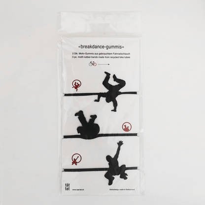 Pack of black breakdance-shaped rubber bands made from recycled bicycle inner tubes, playful eco-friendly office supplies and creative gift wrapping accessories.