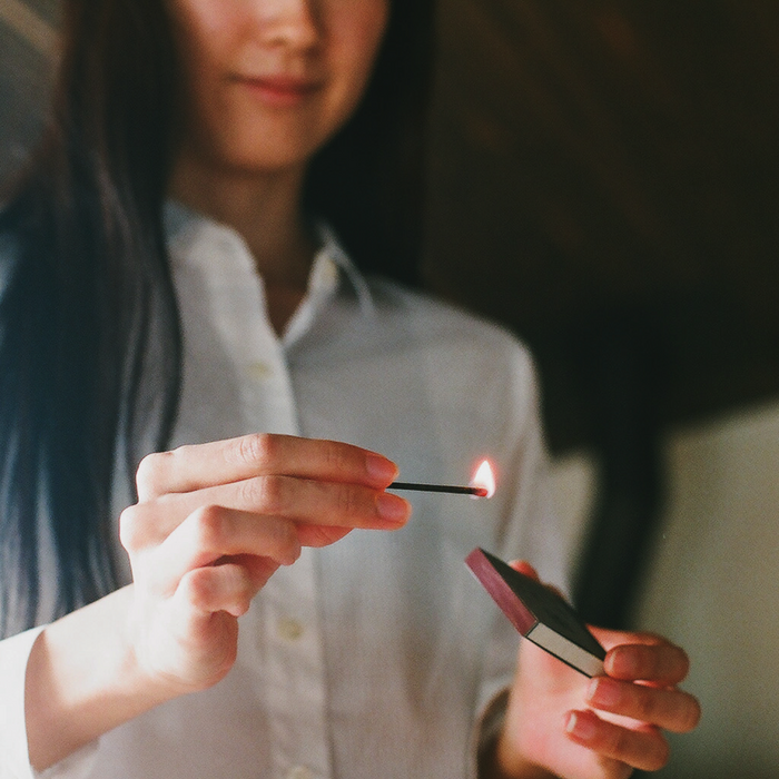 Assorted hibi 10 Minutes Aroma incense matches displayed on a wooden surface, showing multiple scents in open and closed boxes