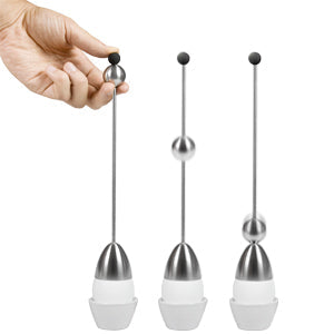 Stainless steel hand bell with long handle and black rubber tip shown in three positions, including hand-held use, displayed on a clean light gray background in a minimalist product demonstration.