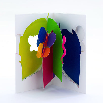 Open 3D pop-up greeting card featuring colorful abstract leaves and flower petals in bright green, blue, pink, orange, and purple, showcased in a bold modern paper art design.