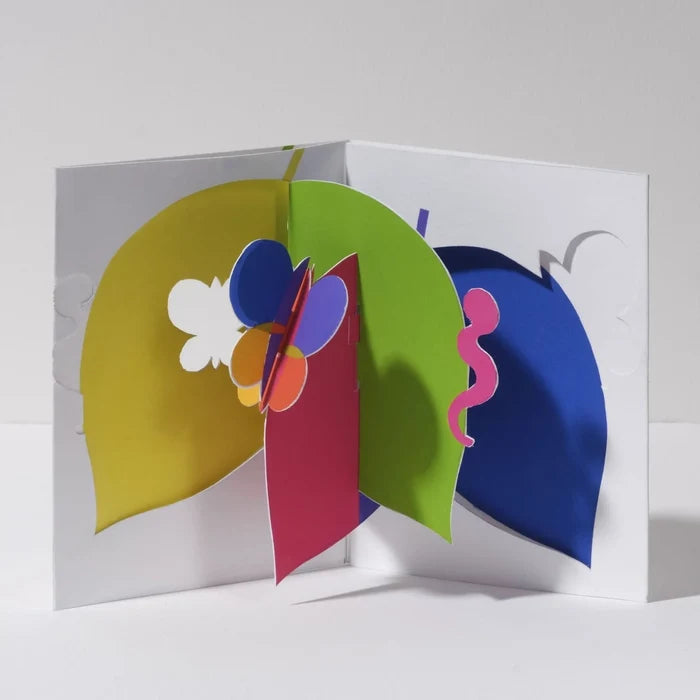 Open 3D pop-up greeting card featuring colorful abstract leaves and a butterfly in bright green, blue, yellow, pink, orange, and purple, showcased in a bold modern paper art design.