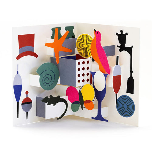 Colorful 3D pop-up greeting card with whimsical paper illustrations including birds, balloons, fish bobbers, a wine glass, shells, and abstract shapes in a playful modern design.