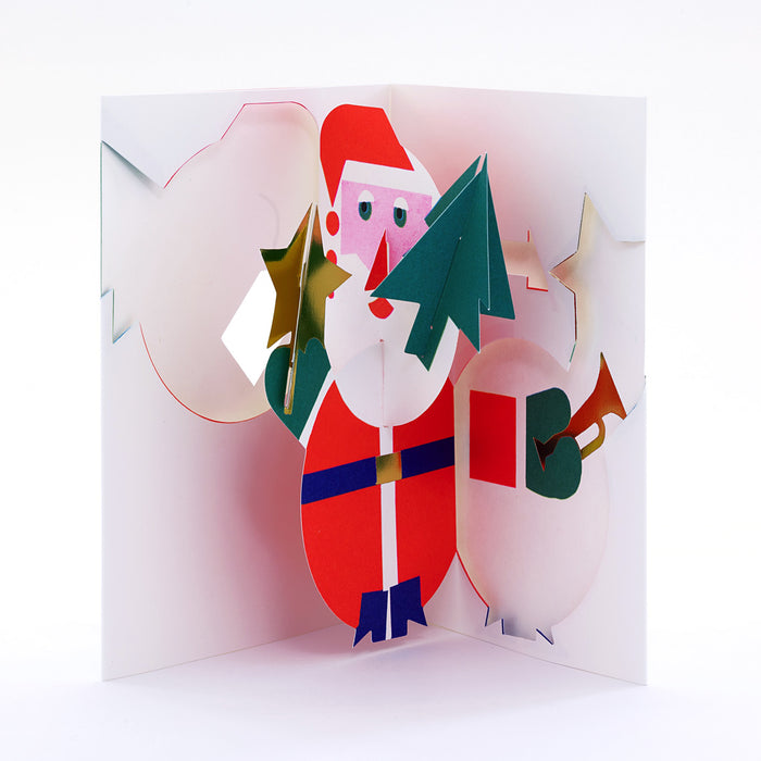 Open 3D pop-up Christmas card featuring Santa Claus holding a gold star and green tree, with a white sack and trumpet in a festive modern paper art design.