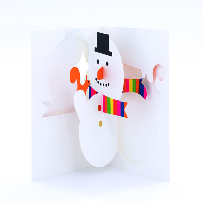 Open 3D pop-up Christmas card featuring a cheerful snowman with a black top hat, orange carrot nose, and rainbow striped scarf in a festive modern paper art design.