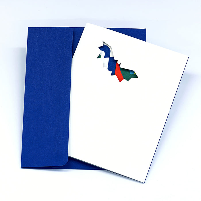 Minimalist Halloween greeting card with a flying witch silhouette cutout on a white cover, paired with a deep blue envelope in a clean spooky seasonal stationery presentation.