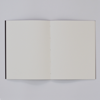 Open TÄT-TAT notebook showing blank high-quality pages, minimalist designer notebook spread for writing, sketching, drawing, and creative journaling.