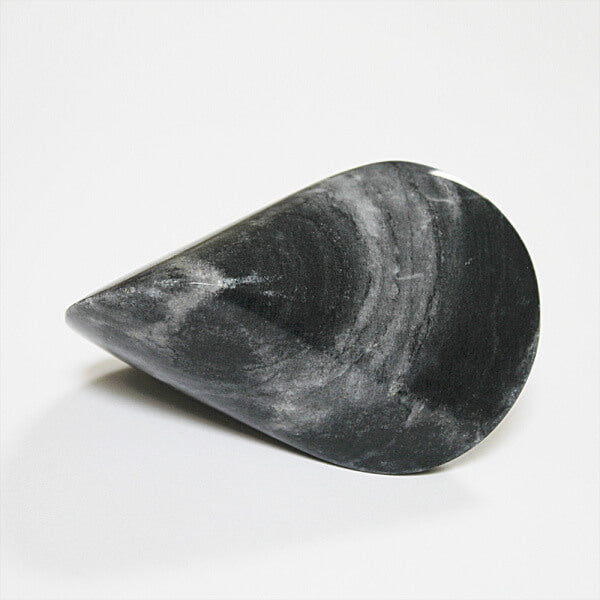 Dark marble oloid sculpture with a smooth teardrop-like geometric form, displayed on a clean white background in a minimalist modern decor product presentation.