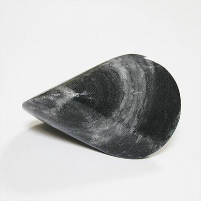 Dark marble oloid sculpture with a smooth teardrop-like geometric form, displayed on a clean white background in a minimalist modern decor product presentation.