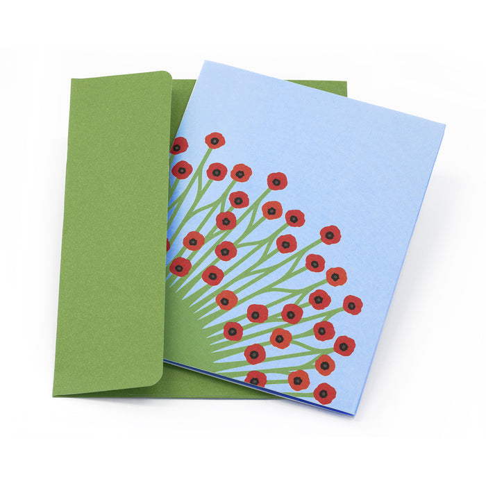 Greeting card with illustrated red poppy flowers on a pale blue cover, paired with a green envelope in a clean, elegant floral stationery presentation.