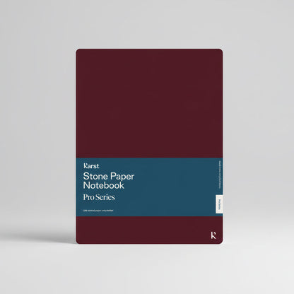 Karst Stone Paper Notebook Pro Series with burgundy cover and blue belly band, shown front-facing on a white background.
