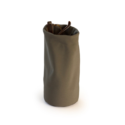 Minimalist soft fabric desk organizer in olive green used as a glasses holder, modern multifunctional container for eyewear, pens, or office accessories.