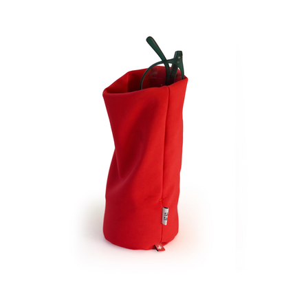 Red soft fabric desk organizer used as a glasses holder, modern multifunctional container for eyeglasses, pens, or office accessories with minimalist design.