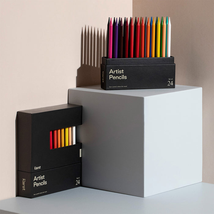 Karst Artist Colored Pencils set of 24 in black box with vibrant woodless colored pencils displayed on pedestal, premium colored pencil set for drawing, sketching, illustration, and art supplies.