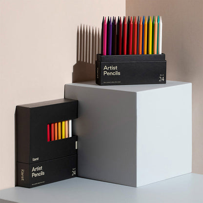 Karst Artist Colored Pencils set of 24 in black box with vibrant woodless colored pencils displayed on pedestal, premium colored pencil set for drawing, sketching, illustration, and art supplies.